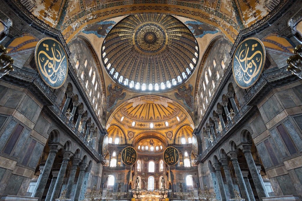 In this picture, Hagia Sophia is seen from the inside, and the Byzantine Seraphim Angels surrounding the magnificent dome are visible together with the calligraphic medallions added by the Ottomans.